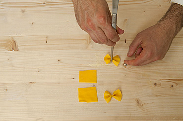 Making Farfalle out of fresh pasta by hand. Italy