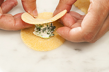 Making fresh tortelli by hand. Italy