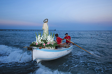 During the procession of the Madonna della Neve on 5 August the statue of the Madonna is taken by rowing boat to the Natarella beach. Savona; Liguria; Italy