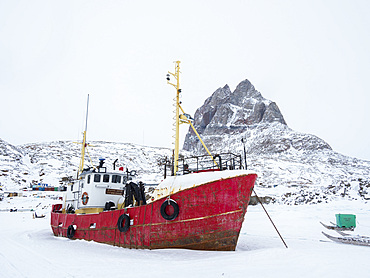 Town Uummannaq during winter in northern Greenland. Ships in the frozen harbour. America, North America, Denmark, Greenland