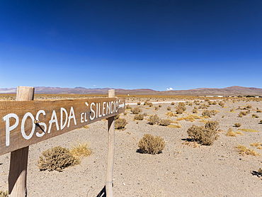 Posada del Silencio, sign near a track at the Salinas Grandes in the Altiplano of Argentina, South America.