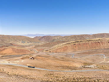 View from Mtn pass Abra de Potrerillos, Salar in the background. Landscape near the salt flats Salar Salinas Grandes in the Altiplano. South America, Argentina