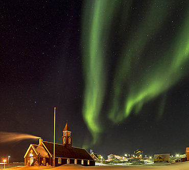 Northern Lights over the Zion s Church. Town Ilulissat at the shore of Disko Bay in West Greenland, center for tourism, administration and economy. The icefjord nearby is listed as UNESCO world heritage. America, North America, Greenland, Denmark