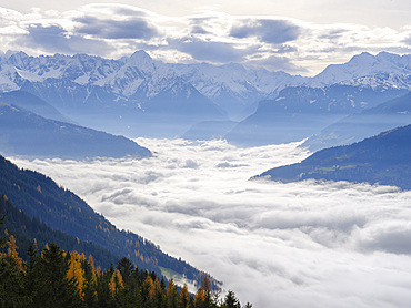 View towards Mayrhofen hidden by a sea of fog. Valley Zillertal near Fuegen during autumn. Europe, Austria, Tyrol