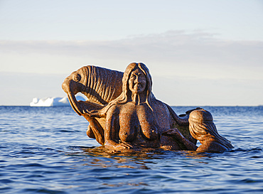 Mother of the sea, Sassuma Arnaa - a legendary figure in Inuit culture. Sculpure by Christian Rosing in the colonial harbour Nuuk the capital of Greenland during late autumn. America, North America, Greenland, danish terriotory