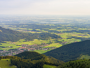 View over the foothills of the Chiemgau Alps and town Aschau in Upper Bavaria. Europe, Germany, Bavaria