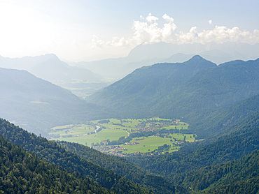 View over the mountains of the Chiemgau Alps towards the valley of river Tiroler Achen and village Schleching in upper bavaria. Europe, Germany, Bavaria