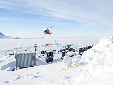 Helicopter is arriving. During winter the helicopter is the only link to the rest of Greenland. The traditional village Kullorsuaq on the shore of the Melville Bay, part of the Baffin Bay, in the far north of Greenland.