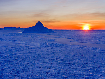 Sunset at the shore of frozen Disko Bay. Disko Bay during winter, West Greenland. America, North America, Greenland, Denmark