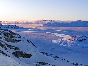 Sunrise during winter at the Ilulissat Icefjord, located in the Disko Bay in West Greenland, the Icefjord is part of the UNESCO world heritage. America, North America, Greenland, Denmark