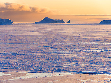 Sunset during winter at the Ilulissat Icefjord, located in the Disko Bay in West Greenland, the Icefjord is part of the UNESCO world heritage. America, North America, Greenland, Denmark