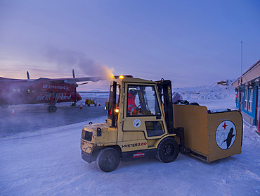 Baggage is unloaded. Upernavik airport. Winter in the town of Upernavik in the north of Greenland at the shore of Baffin Bay. America, Denmark, Greenland