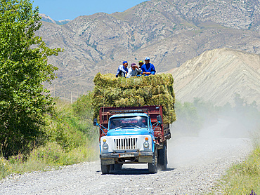 Agriculture in the high plain of river Naryn close to Ak Tal. Transport of hay. Landscape in the Tien Shan mountains or heavenly mountains in Kirghizia. Asia, central Asia, Kyrgyzstan