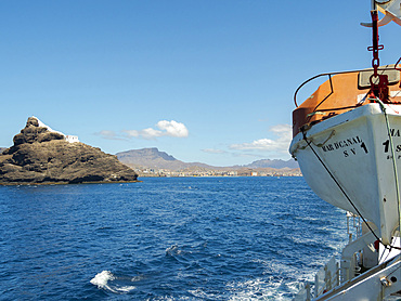 Lighthouse on Ilheu dos Passaros (bird island) at the port entrance. City Mindelo, a seaport on the island Sao Vicente, Cape Verde in the equatorial atlantic. Africa, April