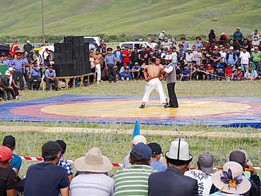 Kuresh, traditional Kyrgyz wrestling. Folk and Sport festival on the Suusamyr plain commemorating Mr Koshomkul, a sportsman and folk hero of the last century. Asia, central Asia, Kyrgyzstan