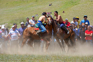 Er Enish or Oodarysh, wrestling from horseback, a traditional equestrian sport. Folk and Sport festival on the Suusamyr plain commemorating Mr Koshomkul, a sportsman and folk hero of the last century. Asia, central Asia, Kyrgyzstan