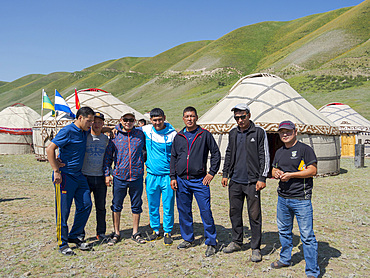 Visitor posing for photographer. Folk and Sport festival on the Suusamyr plain commemorating Mr Koshomkul, a sportsman and folk hero of the last century. Asia, central asia, Kyrgyzstan