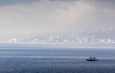 Traditional boat of Lake Como called Lucia in the morning mist, Bellano, Lombardy, Italy, Europe