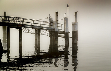 Morning fog on Lake Como, Bellano pier, Navigazione Lariana, Lombardy, Italy, Europe