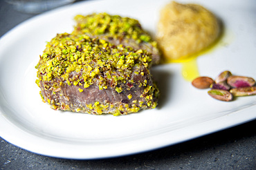 Grilled Sliced Tuna With Pistachios on a White Plate, Italy