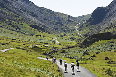 Cyclists ascending Honister Pass, Lake District National Park, Cumbria, England, United Kingdom, Europe