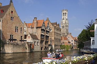 Canal view with a tour launch, Flemish gables and the Belfry tower, Brugge, UNESCO World Heritage Site, Belgium, Europe