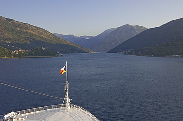 A cruise ship begins its early morning navigation of the winding route to Kotor, Montenegro, Europe