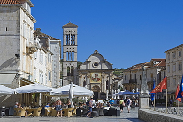 Cafes in the main square with St. Stephen's Cathedral in the medieval city of Hvar, Island of Hvar, Dalmatia, Croatia, Europe