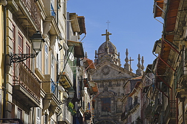 A church dominates a narrow street in the old town, Oporto, Portugal, Europe