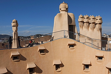 Group of four grotesque chimneys on the roof of La Pedrera (Casa Mila), and roof window details on an apartment block designed by Antonio Gaudi, UNESCO World Heritage Site, Passeig de Gracia, Barcelona, Catalunya, Spain, Europe 