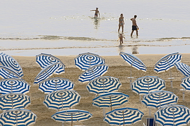 Umbrellas on the beach, family in the sea, Jesolo, Venetian Lagoon, Veneto, Italy, Europe