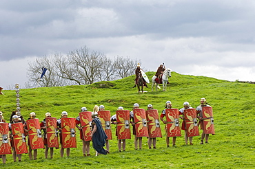 Roman soldiers of Ermine Street Guard, in line abreast with shields and stabbing swords, cavalry in support, Birdoswald Roman Fort, Hadrians Wall, Northumbria, England, United Kingdom, Europe