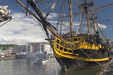 Tall ship Grand Turk, moored in inner harbour, with long boat in attendance, Whitehaven. Cumbria, England, United Kingdom, Europe