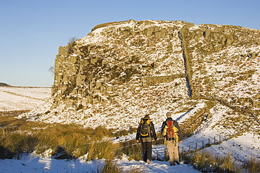 Two climbers head for the crags at Steel Rigg, Hadrians Wall, UNESCO World Heritage Site, Northumbria, England, United Kingdom, Europe