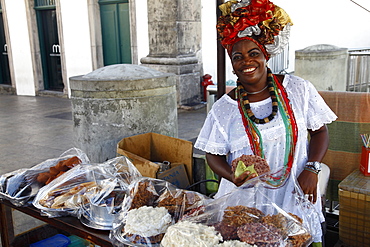 Bahian woman in traditional white dress (Baiana) selling street food at the Pelourinho district, Salvador (Salvador de Bahia), Bahia, Brazil, South America 