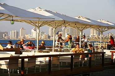 People sitting at Casita Bar and Restaurant in Old Jaffa with a view over the sea and Tel Aviv, Israel, Middle East