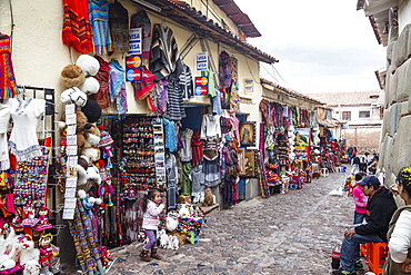 Shops along the the Inca wall at Hathunrumiyoq Street, las piedras del los 12 angulos (the stone of the 12 angles), Cuzco, Peru, South America