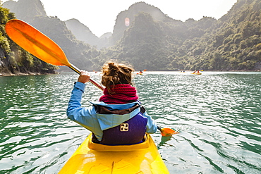 Woman kayaking at Halong Bay, Vietnam, Indochina, Southeast Asia, Asia