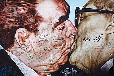 Painting by Russian artist Dimitry Vrubel of Brezhnev kissing Honecker at the remaining section of the Berlin Wall at the East Side Gallery, Friedrichshain, Berlin, Germany, Europe