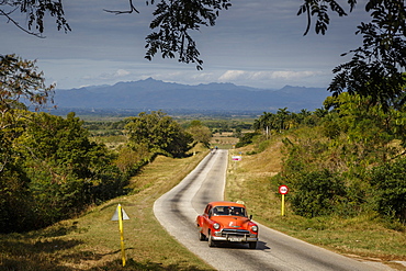 Old vintage American car on a road outside Trinidad, Sancti Spiritus Province, Cuba, West Indies, Caribbean, Central America