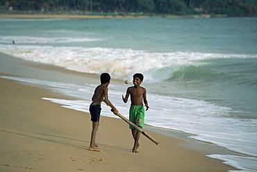 Boys playing cricket, Hikkaduwa beach, Sri Lanka, Asia