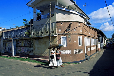 Young women walking round a corner on a street in Galle, Sri Lanka, Asia