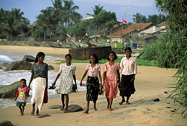 Young girls walking on the beach, Hikkaduwa, Sri Lanka, Asia