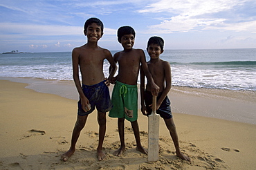 Boys playing cricket, Hikkaduwa beach, Sri Lanka, Asia