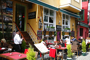 People sitting at an outdoor cafe in the Ortakoy Quarter, Istanbul, Turkey, Europe