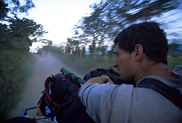 Adventure travel, the road to Rio Dulce from the back of a truck, Guatemala, Central America