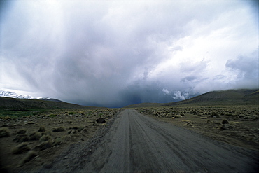 Overcast sky above the road into the Andes mountains, Parque Nacional Volcan Isluga (Volcan Isluga National Park), Chile, South America