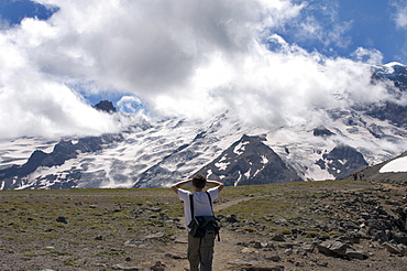 Man looking at Mount Rainier from trail, Mount Rainier National Park, Washington State, United States of America, North America