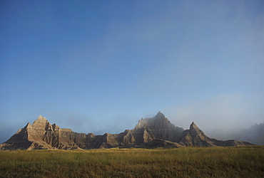 Morning mist rises in Badlands National Park, South Dakota, United States of America, North America