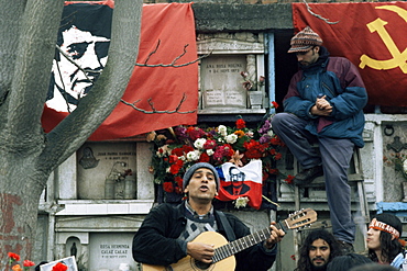 Guitarist plays Victor Jara songs at his grave on 11th de Septiembre, remembering Victor Jara whose hands were cut off in the National Stadium and who was then killed during the Pinochet regime, Santiago, Chile, South America